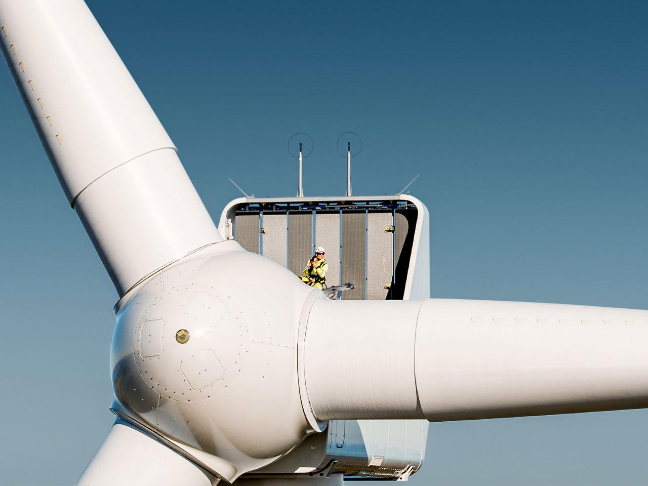 Top of a wind turbine with a Statkraft employee in the top for inspections